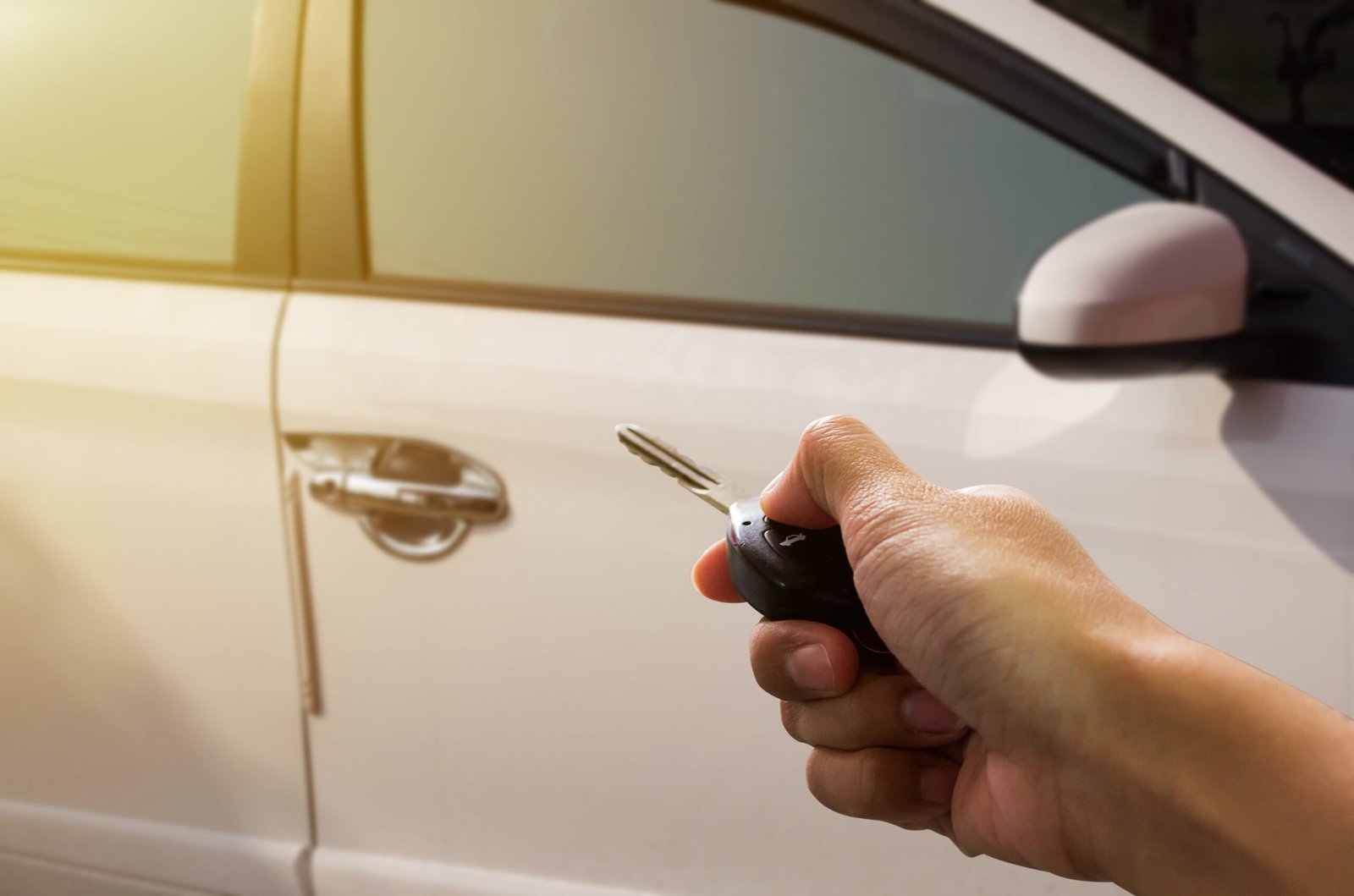 Auto Locksmith Leigh: What Happens If You Lose Your Only Car Key? 1 man using car key fob to open car