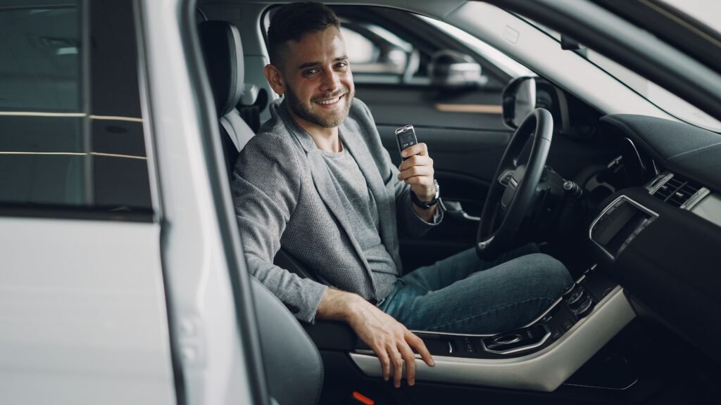 man in car holdig car key