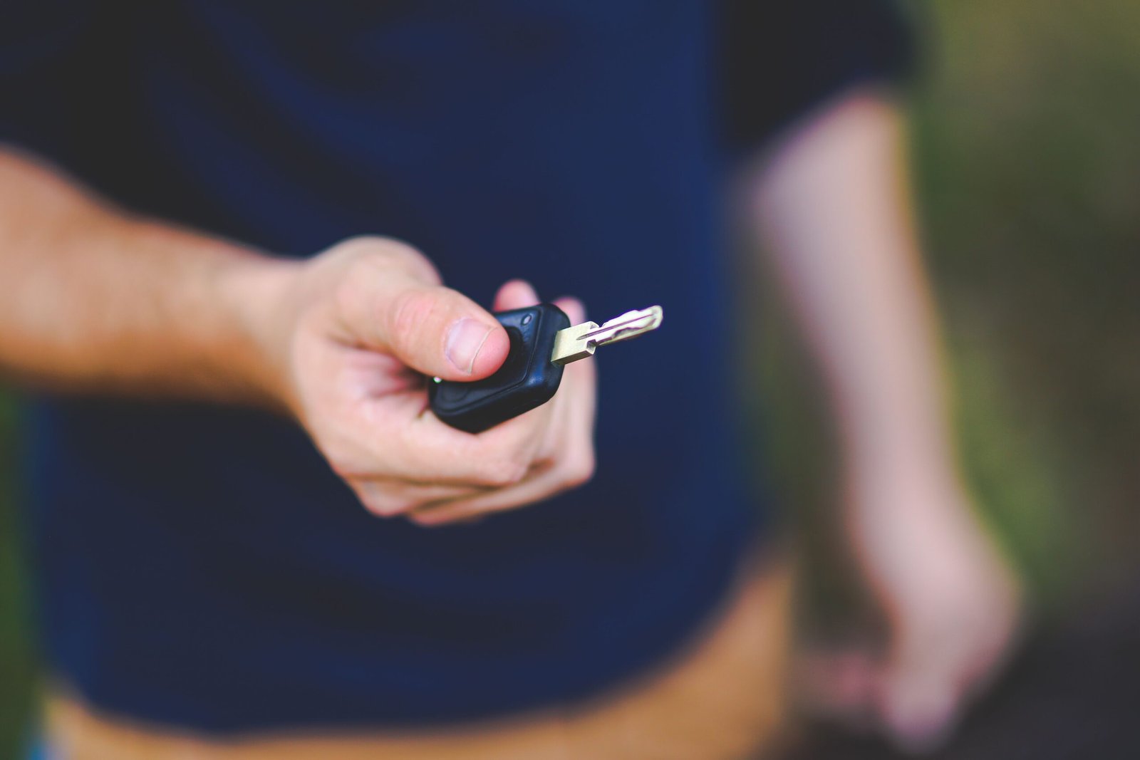 man holding his car key